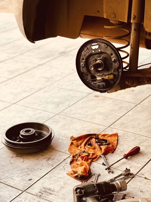 A rear drum brake taken apart with the drum on the floor