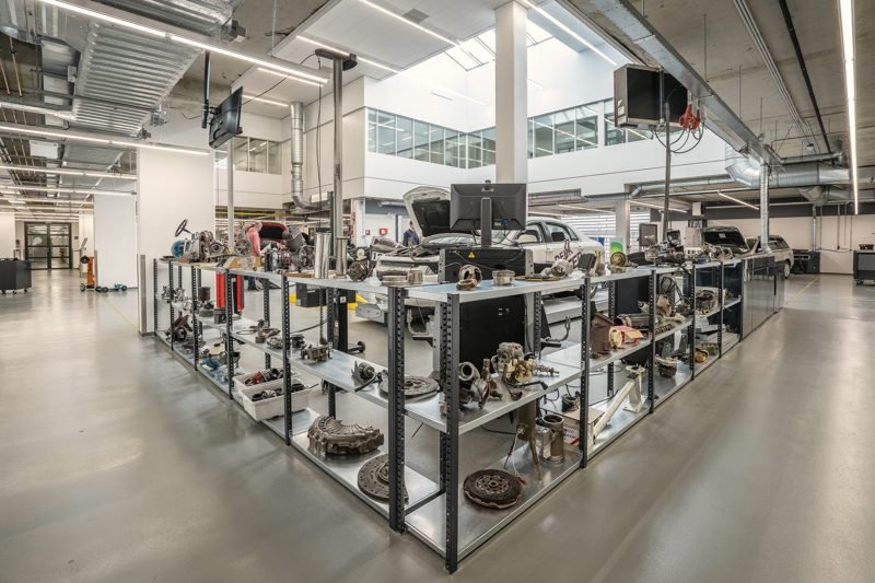 Open metal racks of engine and suspension parts in a bright room